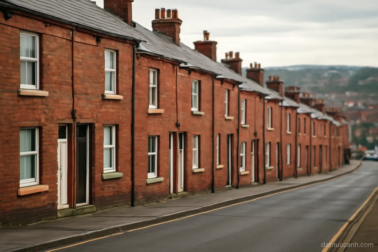 A red brick terraced street on a hillside in a northern town, no readable text